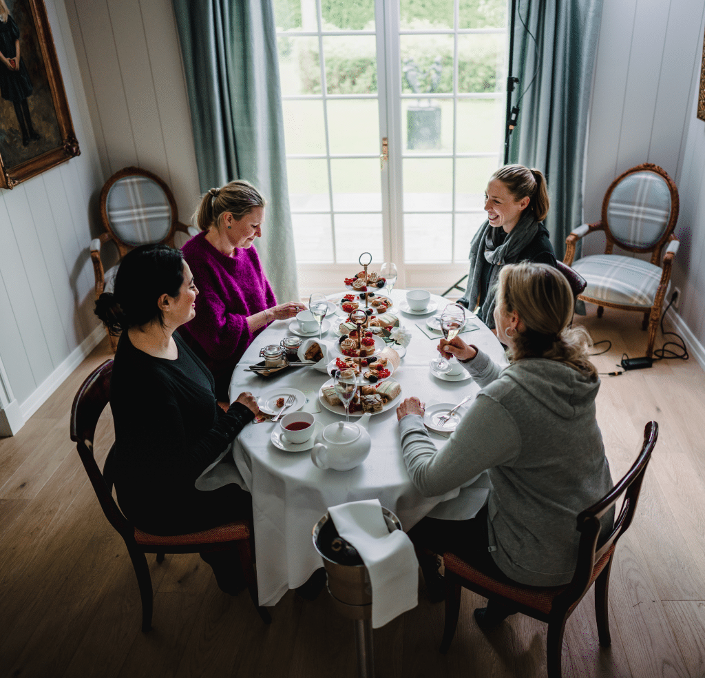 Damer rundt et bord drikker te