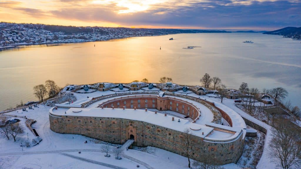 Oscarsborg Fortress in winter garb at sunrise with snow
