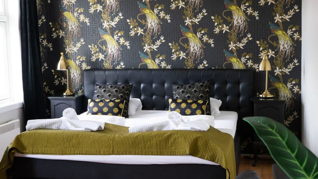 Image of hotel room with peacock wallpaper